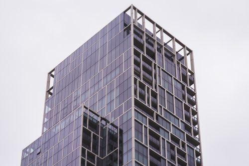 Free A sleek highrise building in Melbourne, showcasing contemporary architecture with a focus on glass and metal elements. Stock Photo