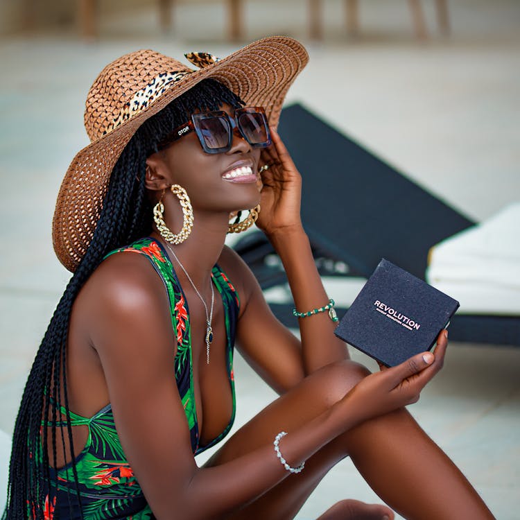 Woman In Printed Swimwear Wearing A Sunhat And Sunglasses