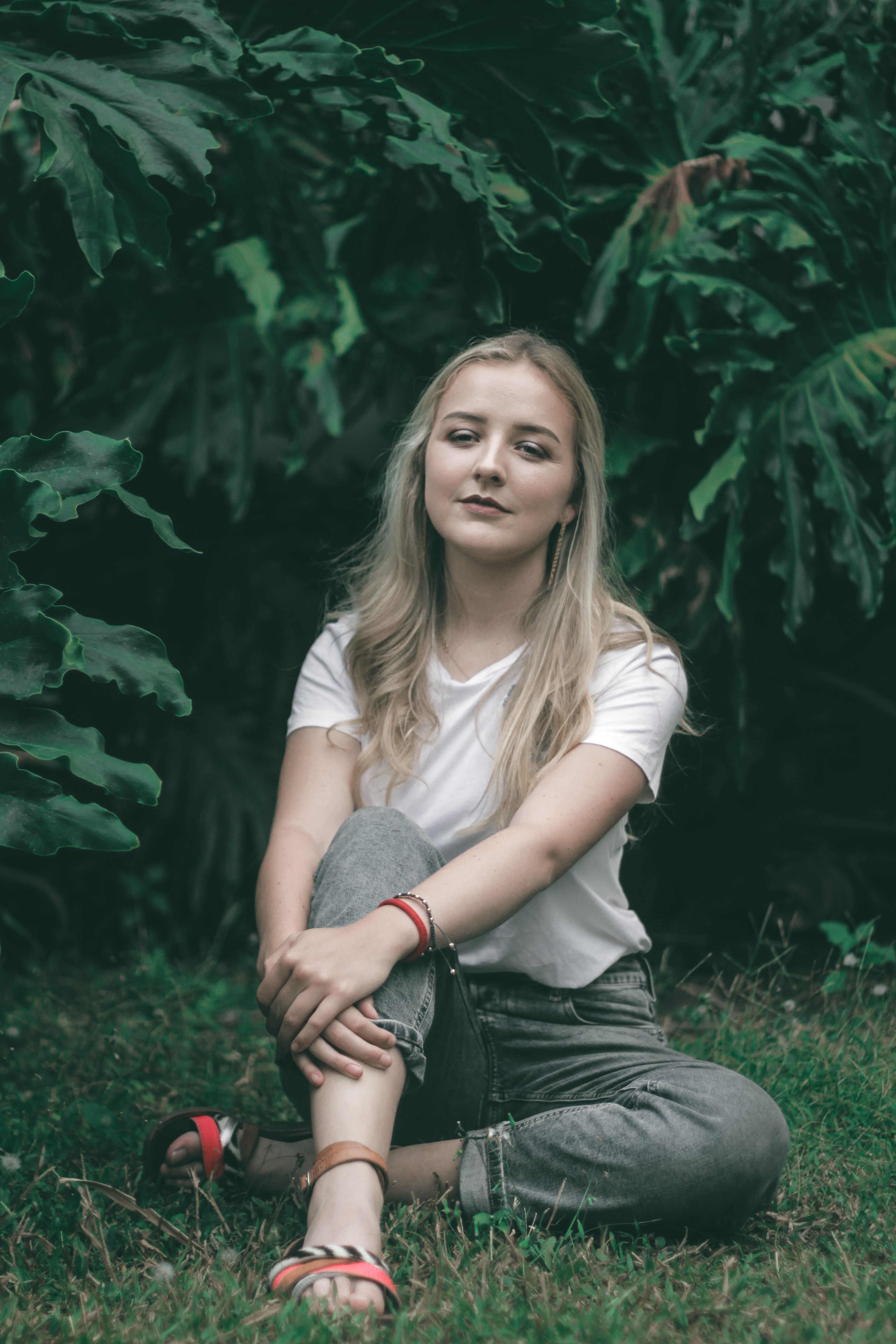 A Woman in White Shirt Sitting on Green Grass · Free Stock Photo