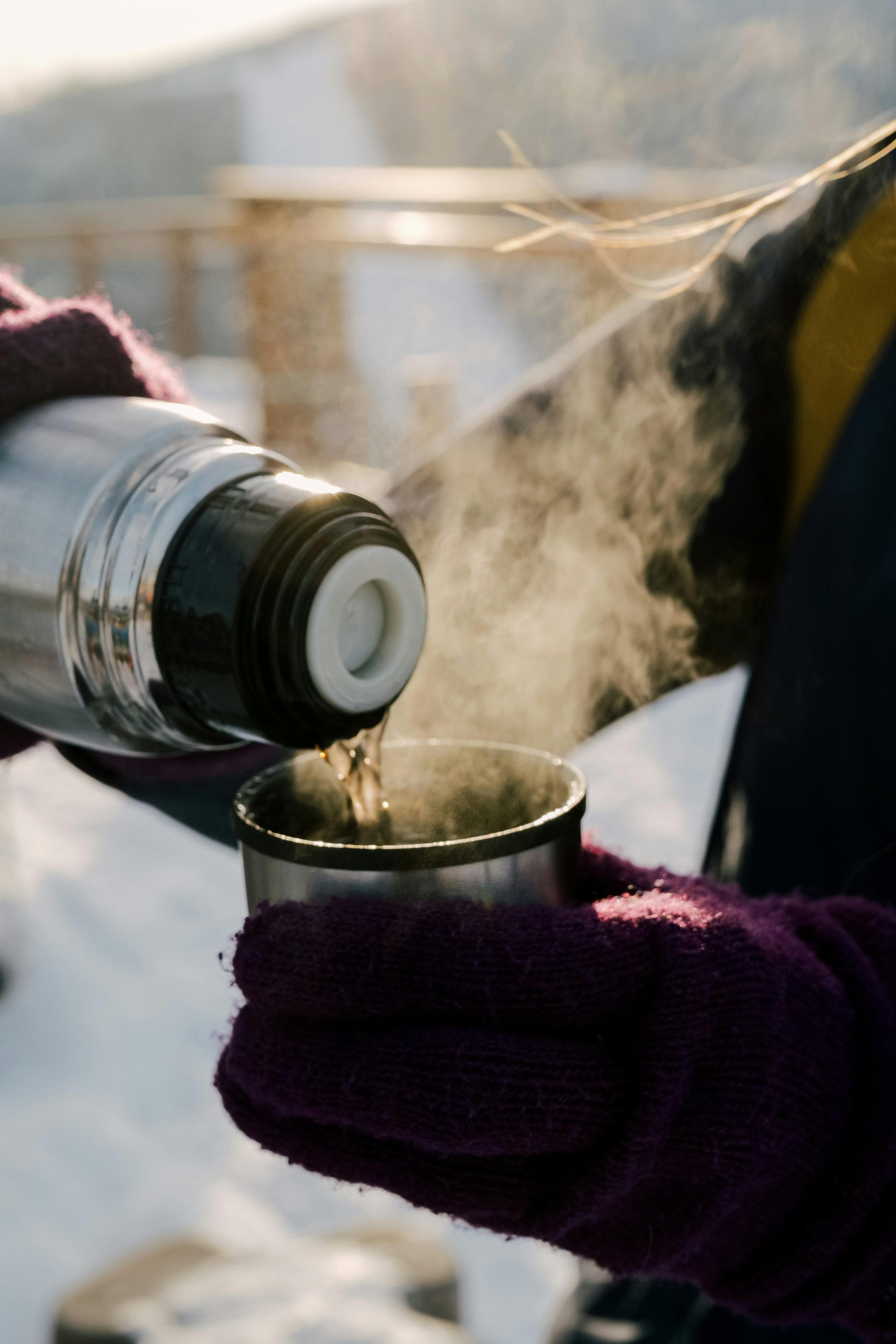 Pouring Hot Tea From Thermos Into Cup Stock Photo - Download Image