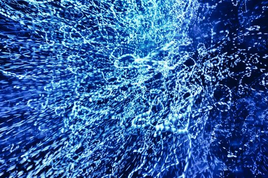 Vivid abstract image of dynamic blue light patterns creating a captivating visual effect.