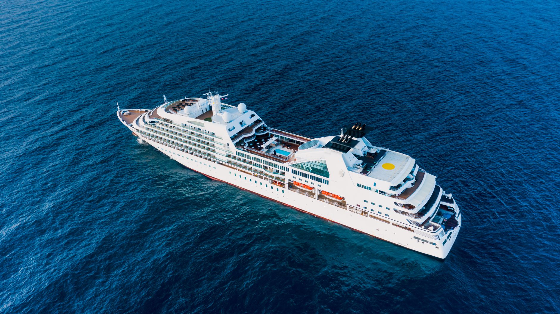 Aerial view of a luxury cruise ship sailing through clear blue ocean waters. — Broward County in Florida