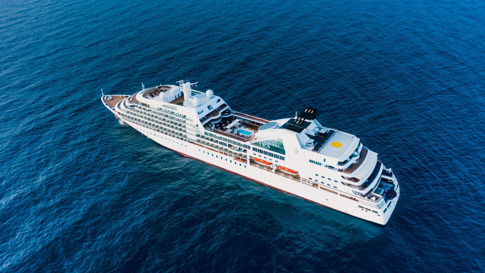 Cruise ship floating on blue sea on a sunny day