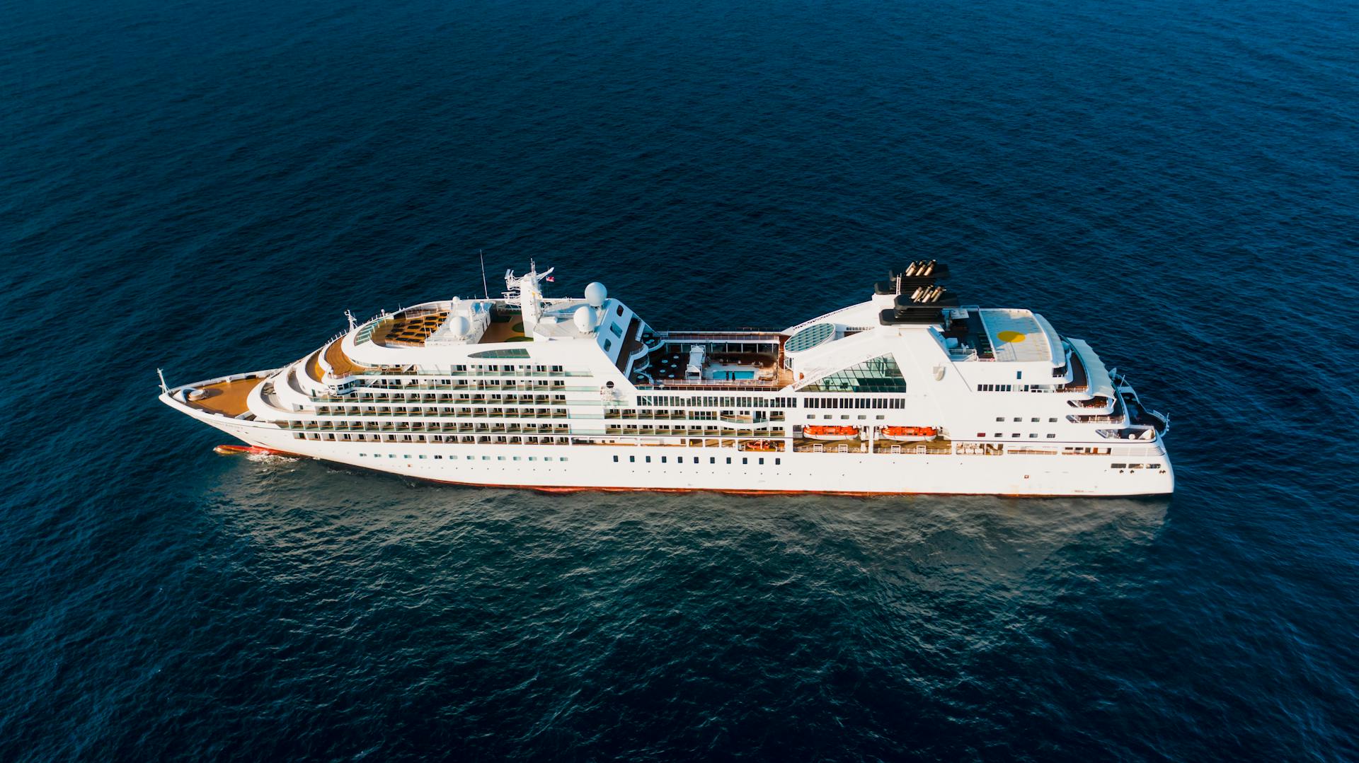 Aerial view of a modern luxury cruise ship sailing in the open blue ocean.