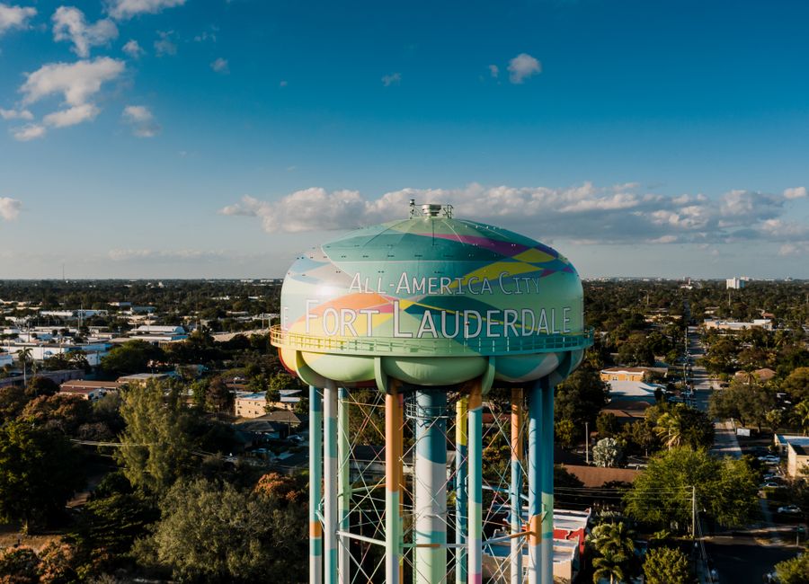 Picturesque drone view of colorful elevated water tower located against cloudy blue sky in Fort Lauderdale