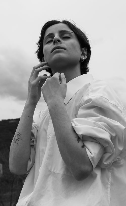 Free Elegant black and white portrait of a woman with tattoos and a button-down shirt. Stock Photo