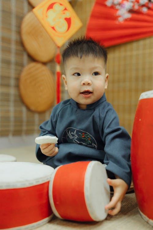 Close-up Photo of Cute Kid in Traditional Chinese Wear 