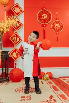 A happy child wearing traditional Vietnamese attire holds a lantern during Tet celebrations.