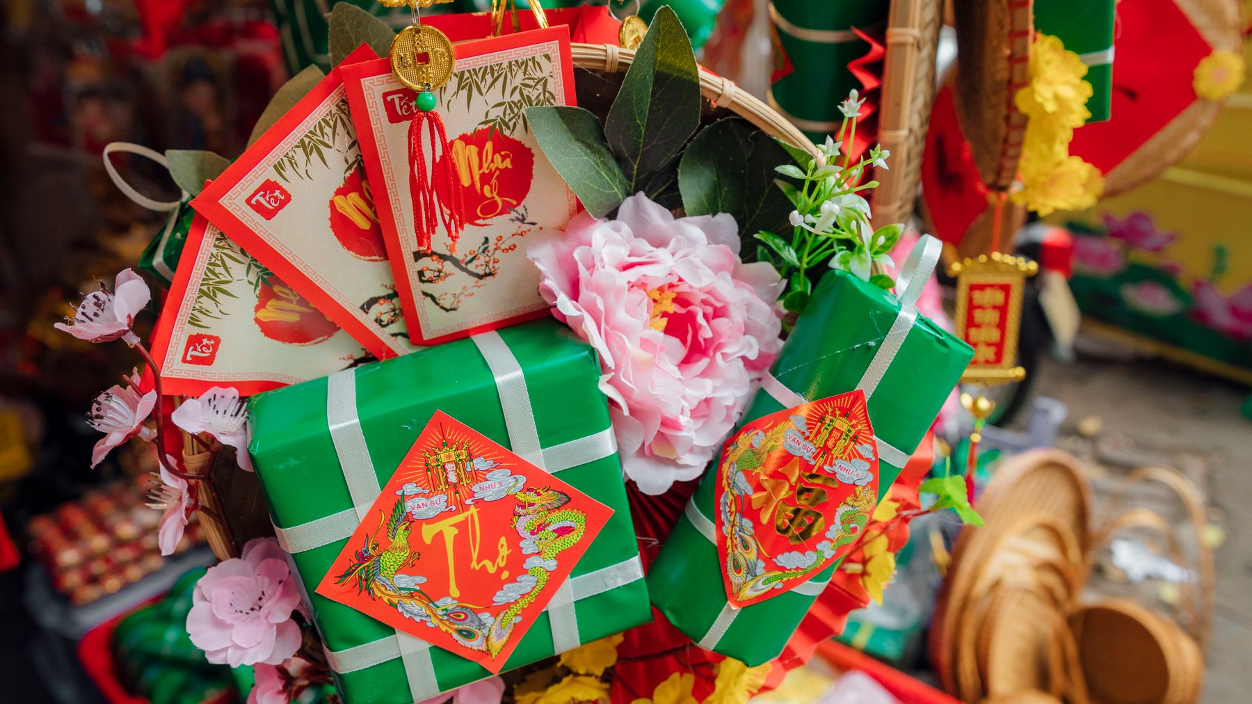 Close-up of celebratory Tet decorations showcasing traditional Vietnamese gift boxes and floral display.
