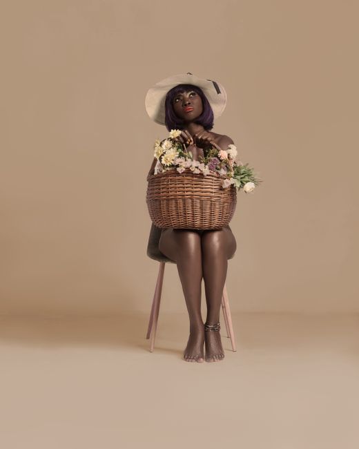Fashionable woman with purple hair sitting with a woven basket against a beige background.