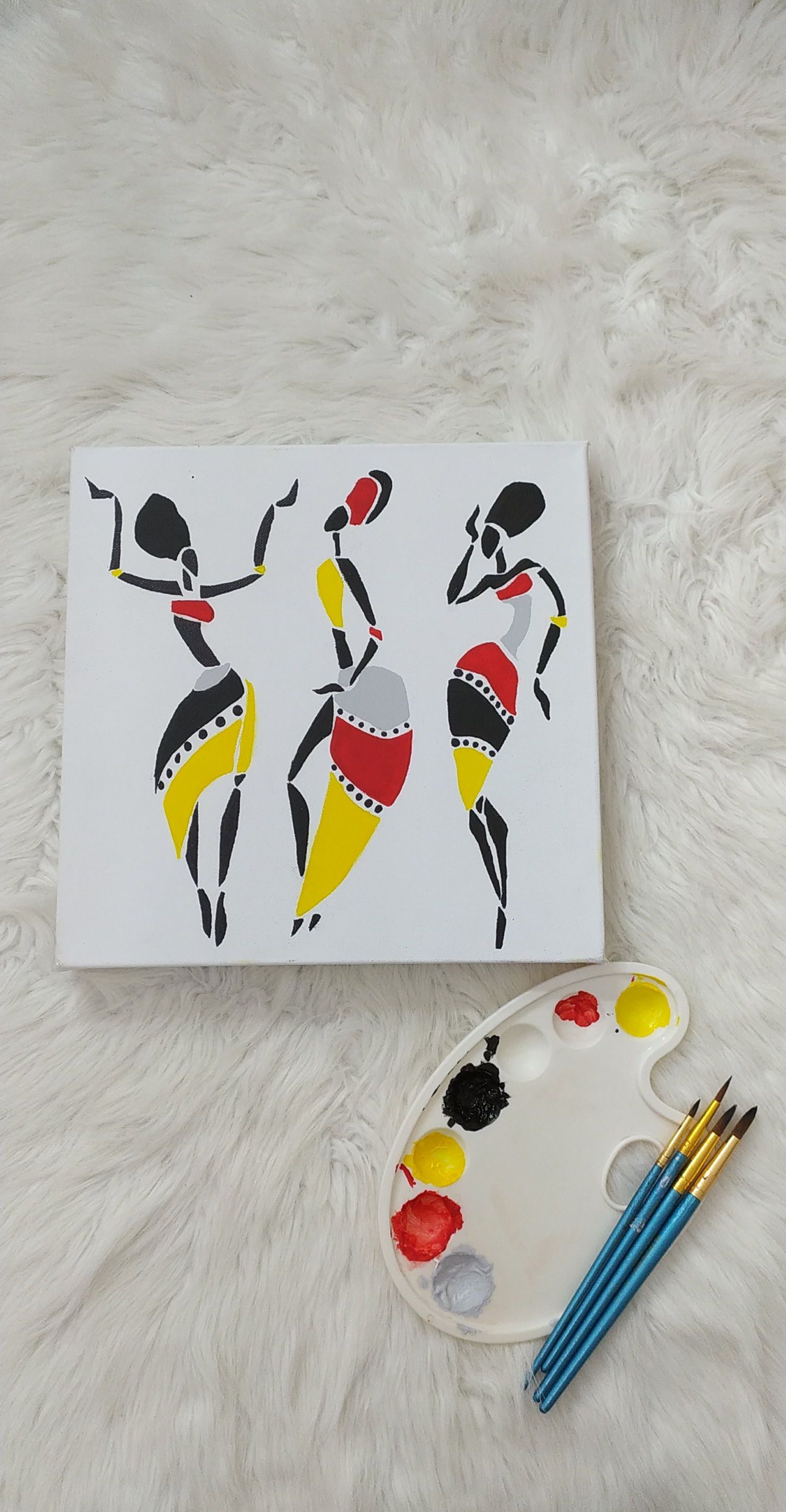 Bright abstract painting of dancers with paint palette on fluffy surface.