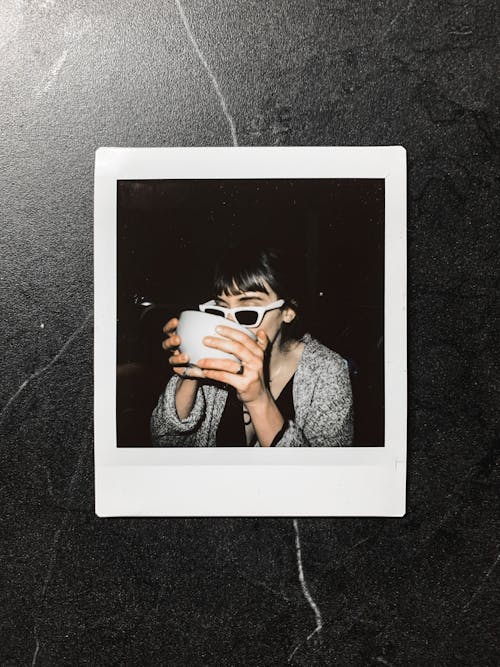 Instant photo of woman with cup