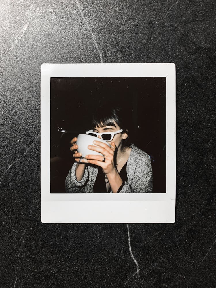 Instant Photo Of Woman With Cup