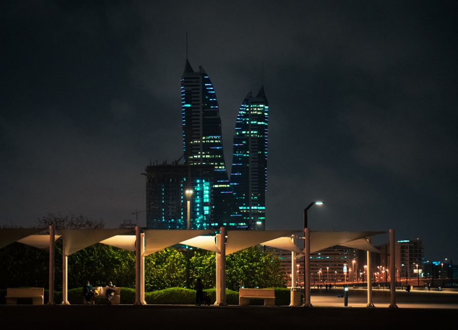 Stunning night view of Bahrain's skyline with illuminated modern towers and cityscape.