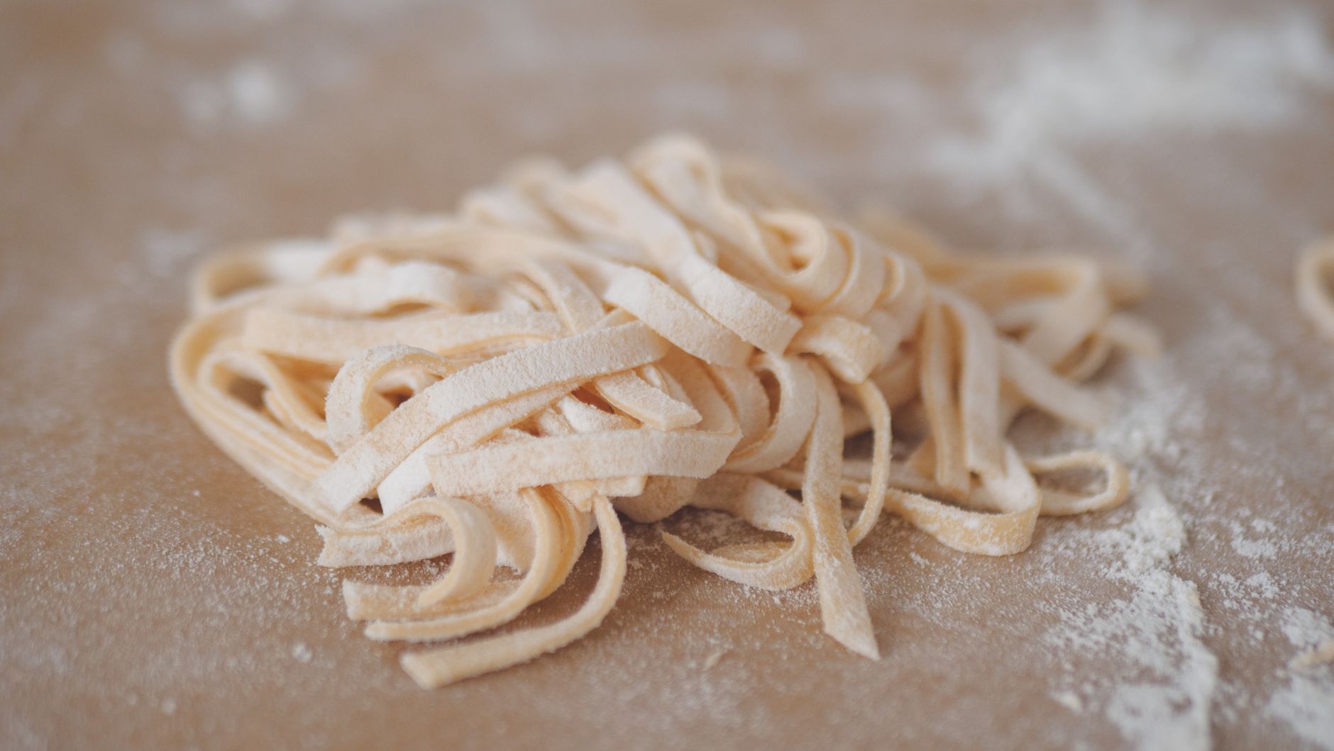 Open package of bronze cut pasta showing rough texture on individual noodles