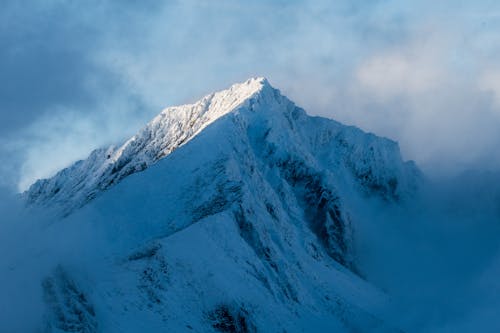 Free Snow Covered Mountain surrounded with Fog  Stock Photo