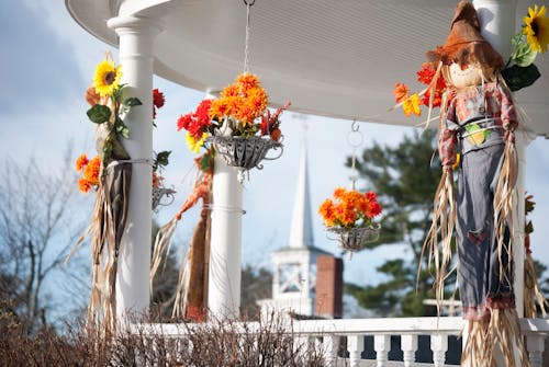 Free Small scarecrows decorating veranda pillars of modern rural cottage Stock Photo