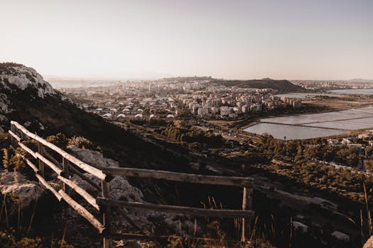 Beautiful panoramic view of Sardinia's urban landscape from a hillside at sunset.