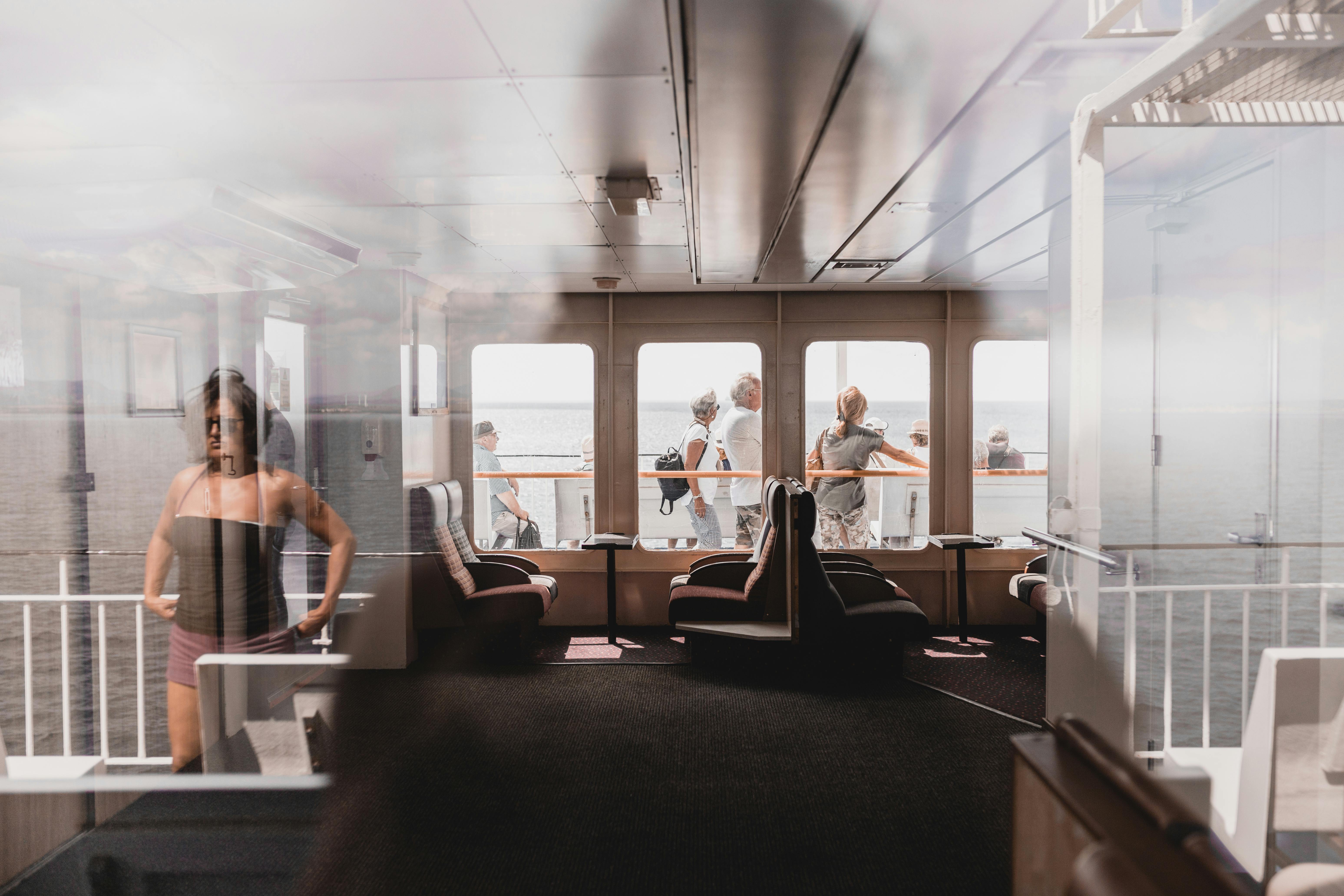 Free Passengers enjoy a sunny ferry ride with sea views in Sardinia, Italy Stock Photo