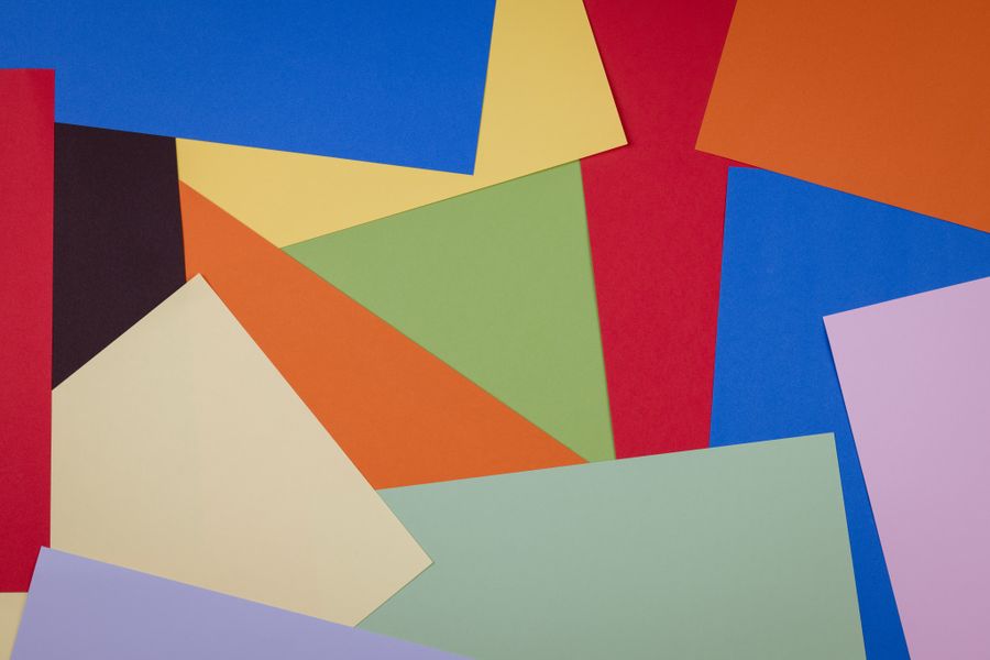 Overlapping sheets of coloured paper in a studio still life — photo by Engin Akyurt on Pexels