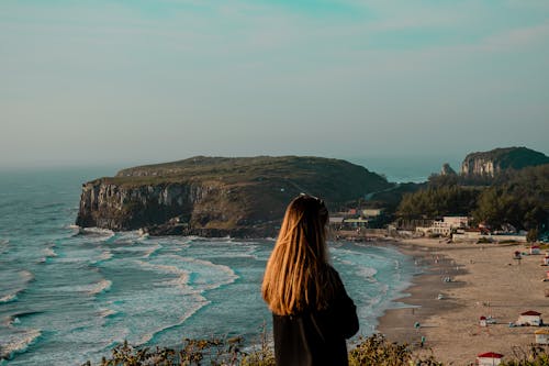 Free Backview of Woman standing on a Cliff  Stock Photo