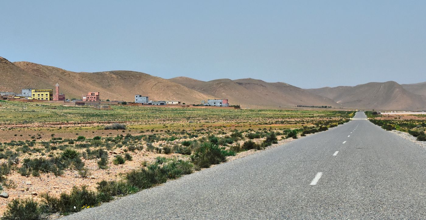 Open road leading toward mountains near Irherm in southern Morocco