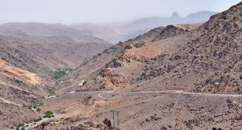 Free Vast rocky landscape of Irherm, Morocco with winding roads and distant mountains. Stock Photo