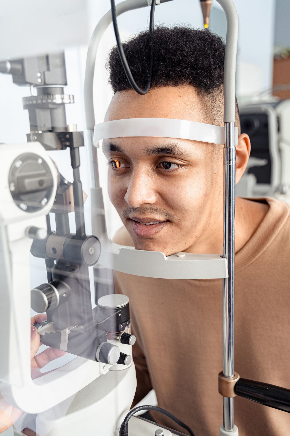 A man having his eyes examined with ophthalmology equipment