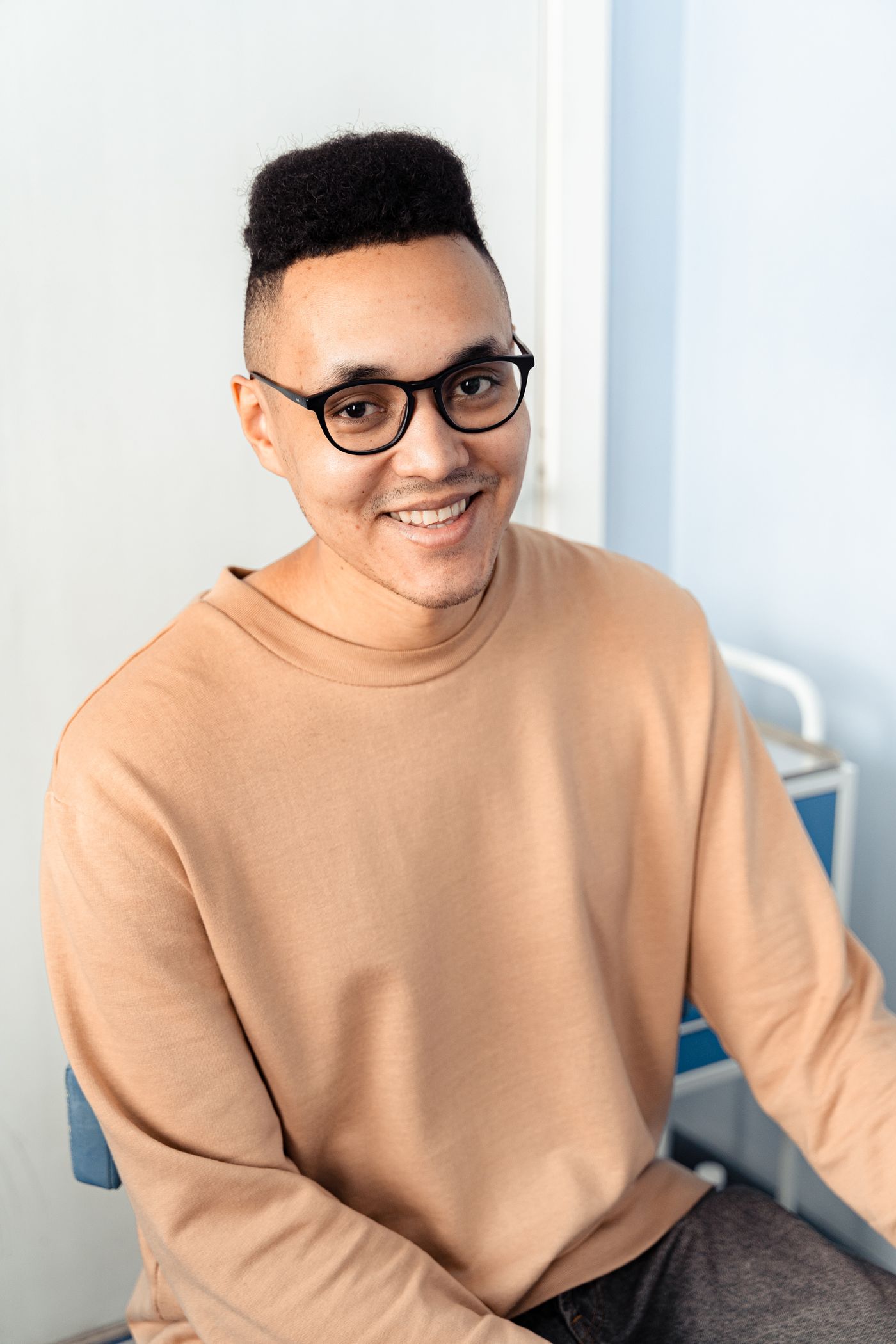 Customer wearing clear optical frames indoors