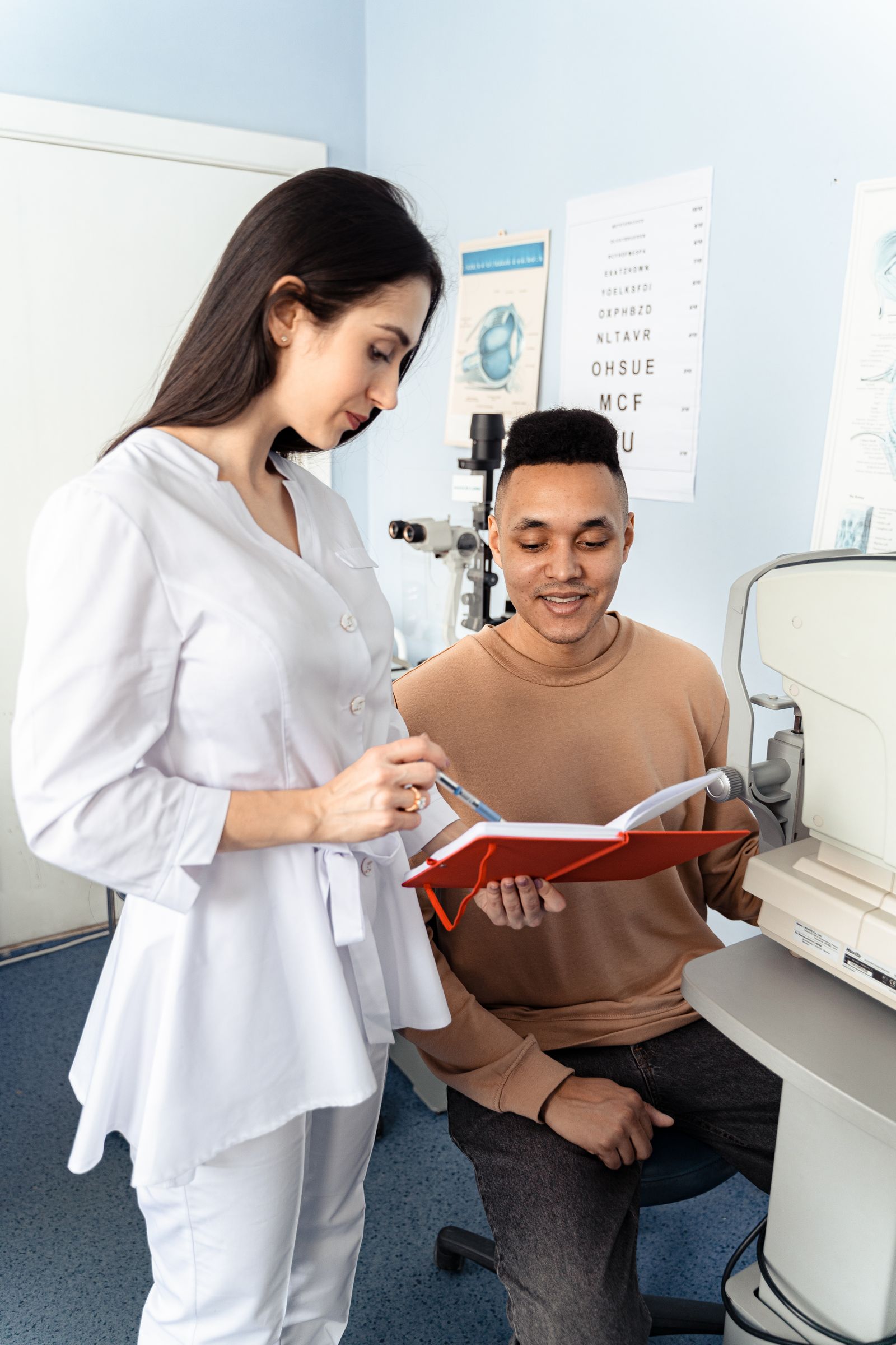 Eye-care professional assisting a patient during a clinical appointment