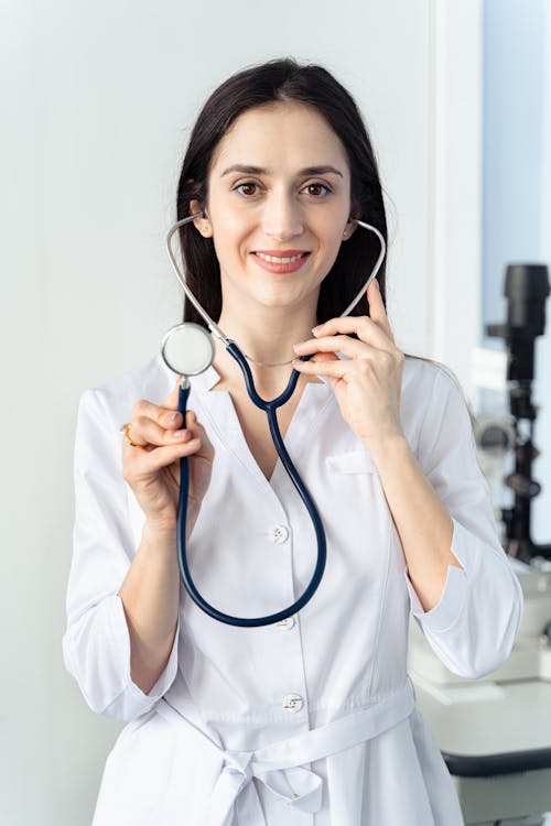 Woman Smiling while Holding a Stethoscope 