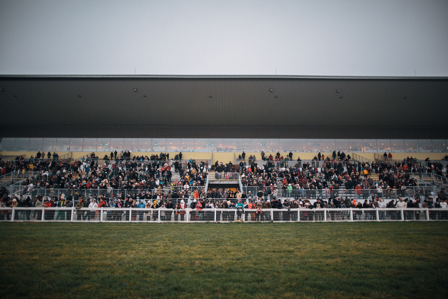 A large crowd gathers at a grandstand in Budapest, Hungary, for an outdoor sports event.