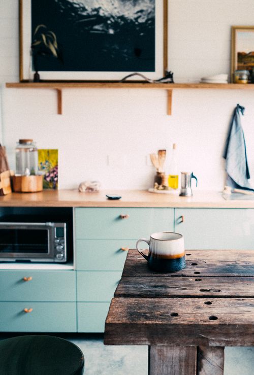 Free A rustic kitchen setting with a wooden table and coffee mug, exuding warmth and coziness. Stock Photo