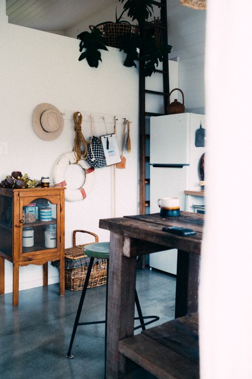 Free Cozy kitchen corner featuring rustic wood furniture and vintage decor for a homely atmosphere. Stock Photo