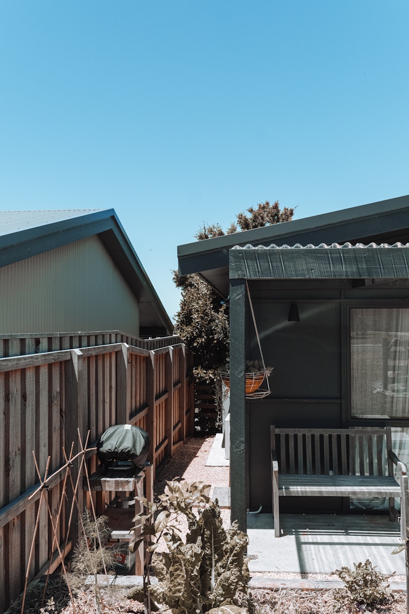 Residential backyard with wooden deck and patio during daytime