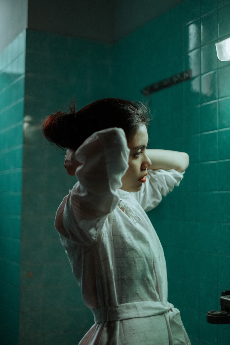 Woman In White Dress Fixing Her Hair