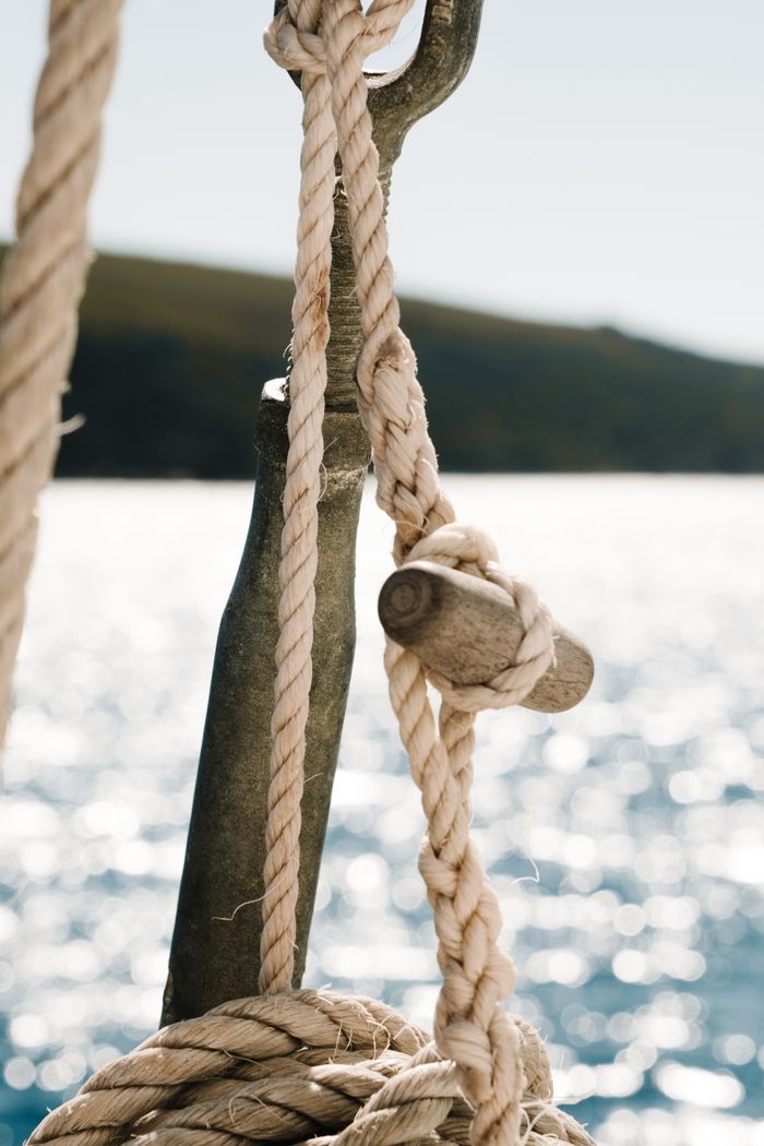 Mooring ropes and rigging on a boat above open water — photo by Rachel Claire on Pexels