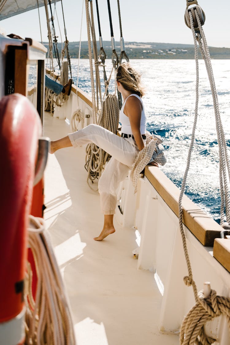 Woman Leaning On A Dock Of A Boat 