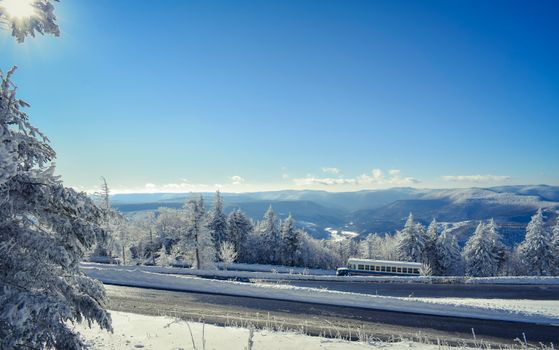 Breathtaking winter view featuring snow-covered mountains and a clear blue sky.
