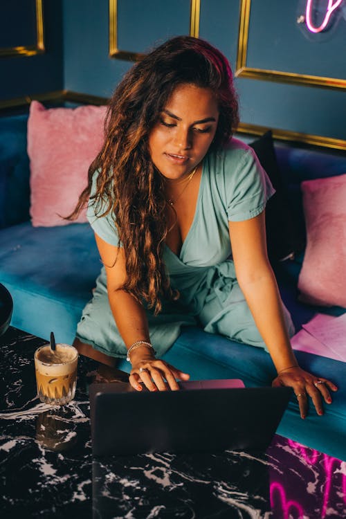 Woman in Blue Shirt Using Laptop