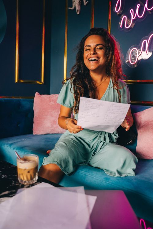 Paper Laughing A Woman Holding a Paper Laughing · Free Stock Photo