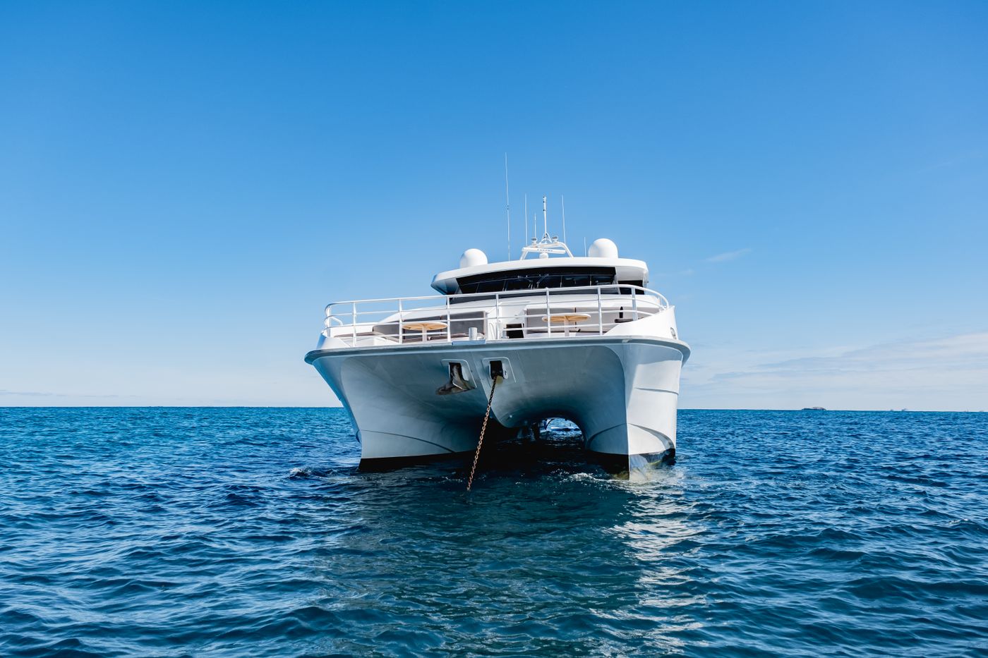 White luxury motor yacht cruising open sea