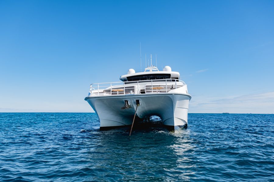 White luxury motor yacht cruising open sea