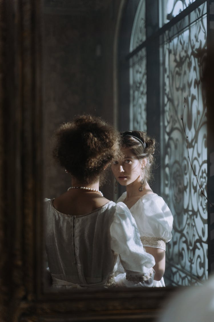 Women Reflection On A Wall Mirror