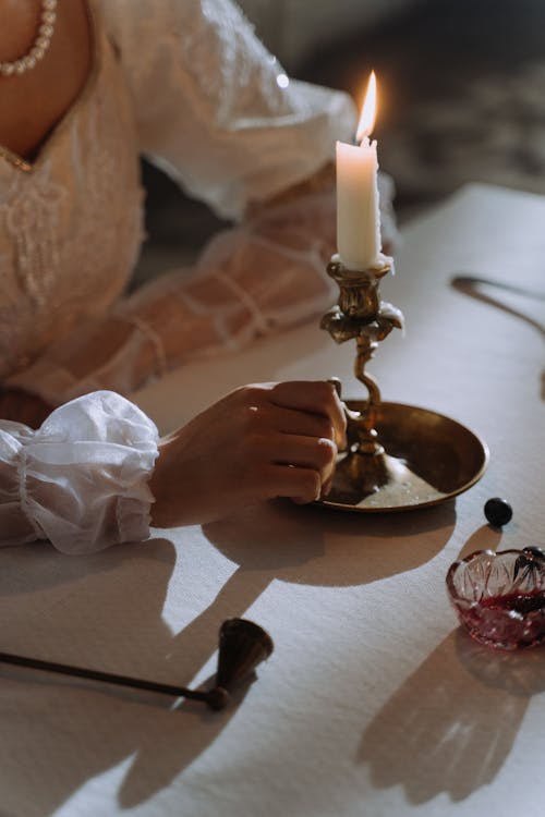 A Person Holding a Candle Holder 