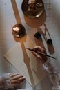 Person holding Quill Pen over a Blank Paper