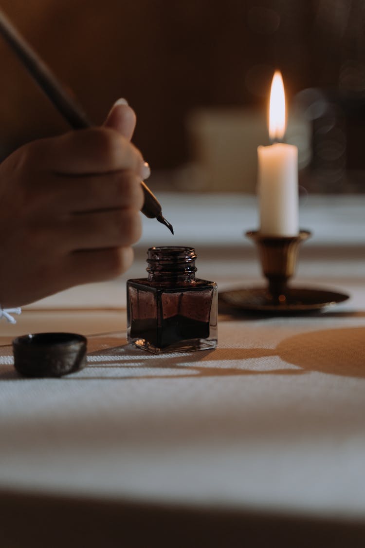 Person Dipping Quill Pen In An Ink 