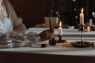 Person dipping Quill Pen in an Ink