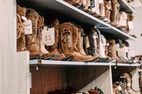 Boots on retail shelving — photo by Rachel Claire on Pexels