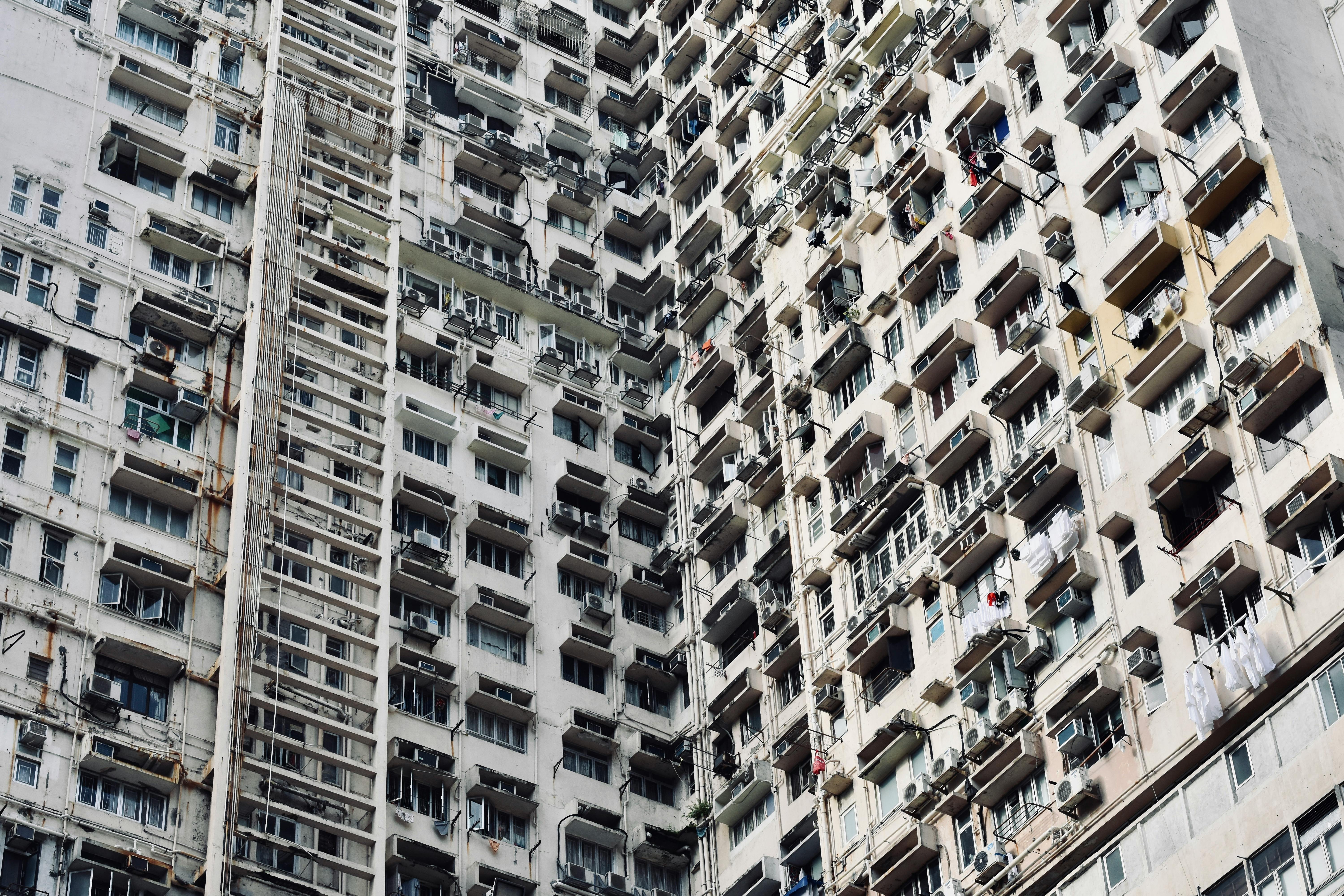 A detailed view of a high-rise apartment building in Hong Kong, showcasing urban density.